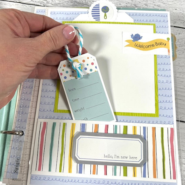 Baby Boy Scrapbook Album page with a striped pocket, a cute tag, and blue twine