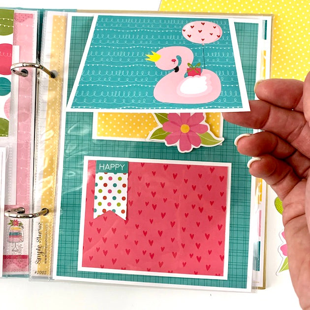 Birthday scrapbook album page with hearts, flowers, and pink flamingo