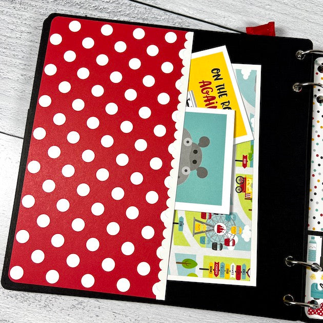Disney themed scrapbook page with polka dot pocket and journaling cards