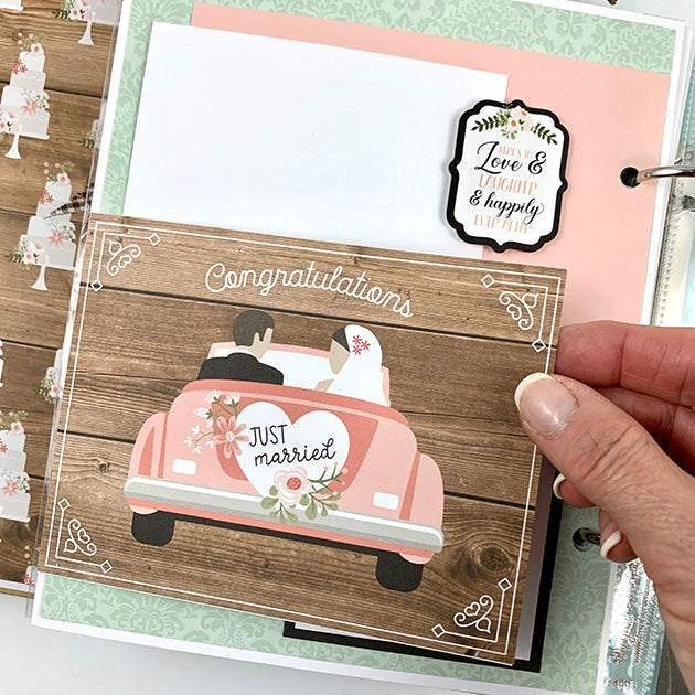 Our Wedding Day Scrapbook Album Page with lots of pretty flowers and cakes, a just married car, a folding element, and woodgrain papers