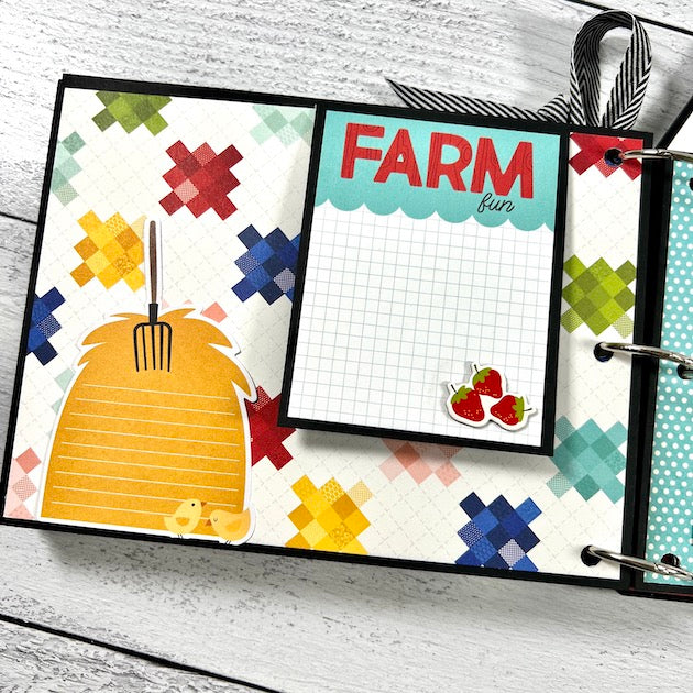 Farm Scrapbook mini album page with a colorful quilt pattern, a folding card, strawberries, and journaling spot that's shaped like a pile a hay