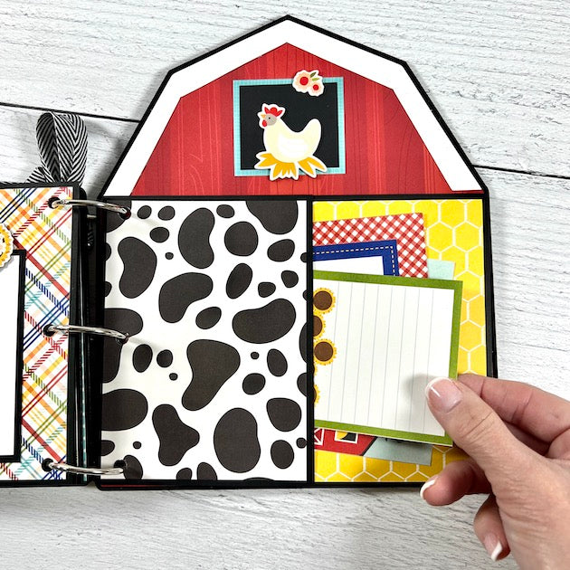 Farm Scrapbook mini album page that's shaped like a barn with a fun pocket, journaling cards, a rooster, and a cow print