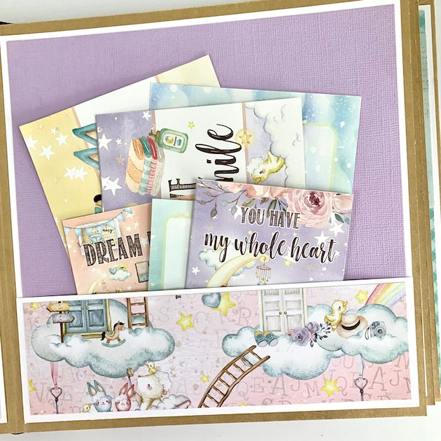 Hello Baby Scrapbook Album page with clouds, baby animals, a pocket, journaling cards, and lavender paper