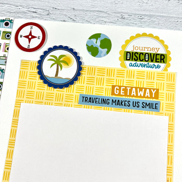 12x12 travel scrapbook page with palm tree, earth and cameras