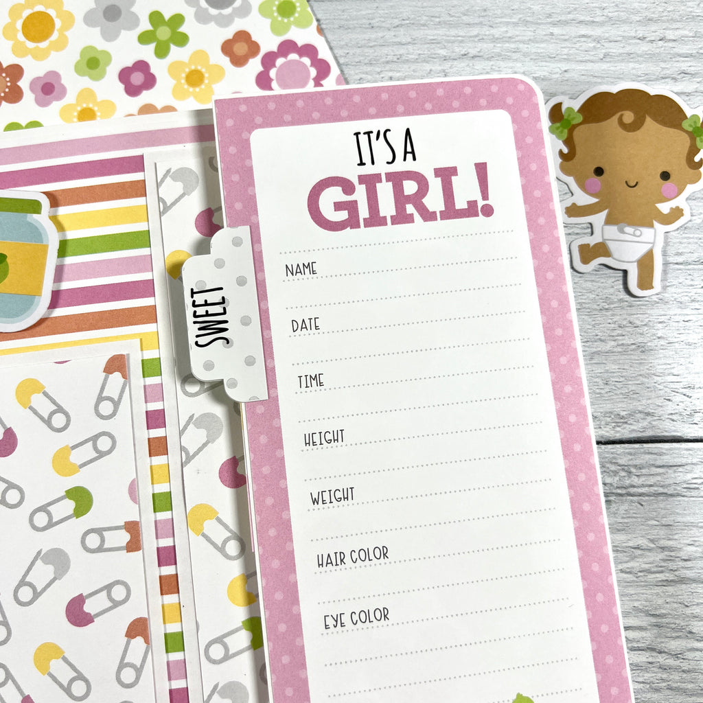 Baby girl scrapbook album page with with journaling card