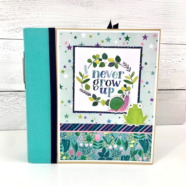 Never Grow Up Scrapbook Album with a frog, stars, and plants