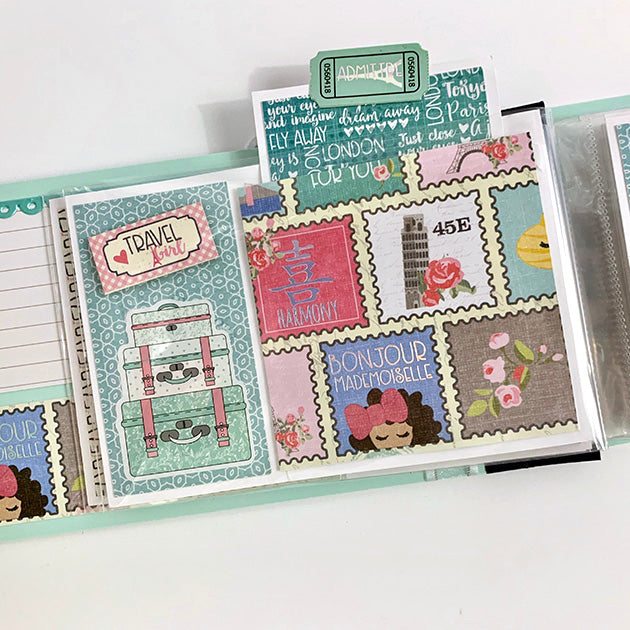 Travel Girl Scrapbook album with stamps, flowers, and luggage