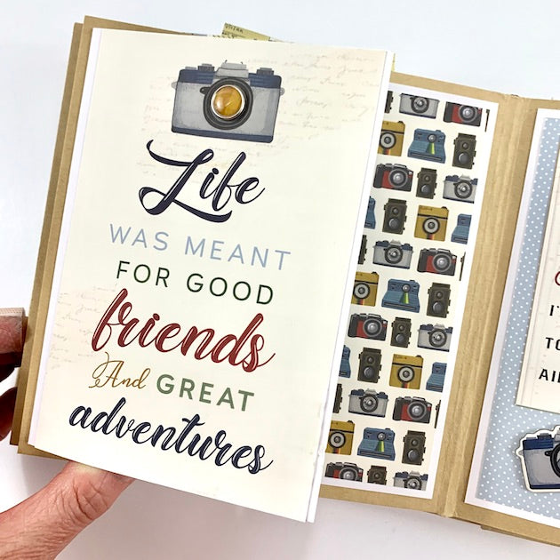 Our Greatest Adventure Travel Scrapbook Album Page with a folding element, lots of cute cameras, and an enamel brad