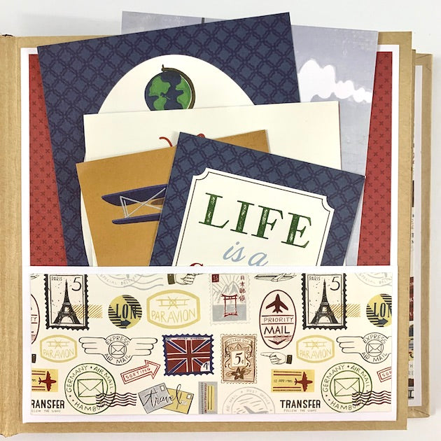 Our Greatest Adventure Travel Scrapbook Album Page with a pocket, travel stamps, and lots of fun journaling cards